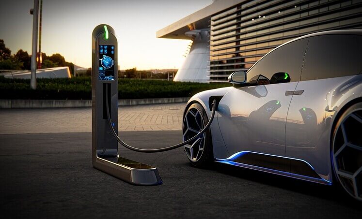An electric car charging at a charging station